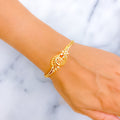 Gold bracelet on a wrist with a marble background
