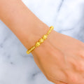 Fine Reflective Striped Orb 22k Gold Bracelet