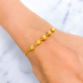 radiant-draped-22k-gold-orb-bolo-bracelet