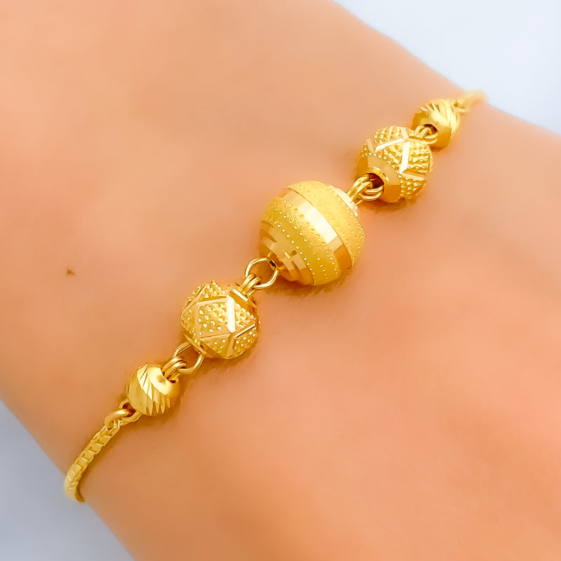 alternating-striped-22k-gold-orb-bolo-bracelet