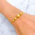 alternating-striped-22k-gold-orb-bolo-bracelet