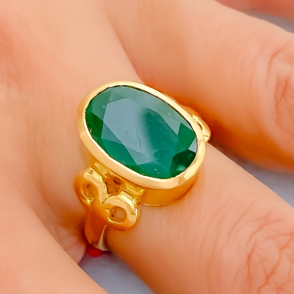Fashion gold ring with natural green emerald on glitter background Stock  Photo - Alamy