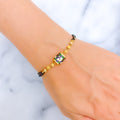 Fancy Floral 22k Gold Black Bead Bracelet 