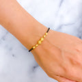 Upscale Twin Orb 22k Gold Black Bead Bracelet 