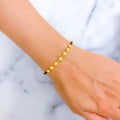 Exclusive Striped 22k Gold Black Bead Bracelet 