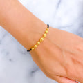 Versatile Wavy orb 22k Gold Black Bead Bracelet