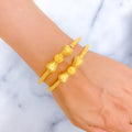 Upscale Striped Cone Adorned 22k Gold Pipe Bangles