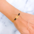 dazzling-flower-22k-gold-black-bead-bracelet