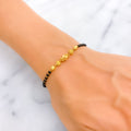 shimmering-graceful-22k-gold-black-bead-bracelet