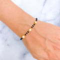 elegant-orb-22k-gold-black-bead-bracelet