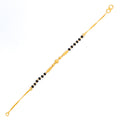 slender-noble-22k-gold-black-bead-baby-bracelet