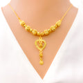 lavish-dangling-heart-21k-gold-necklace