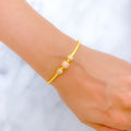 22k-gold-Charming Rose Gold Accented Orb Bangle Bracelet