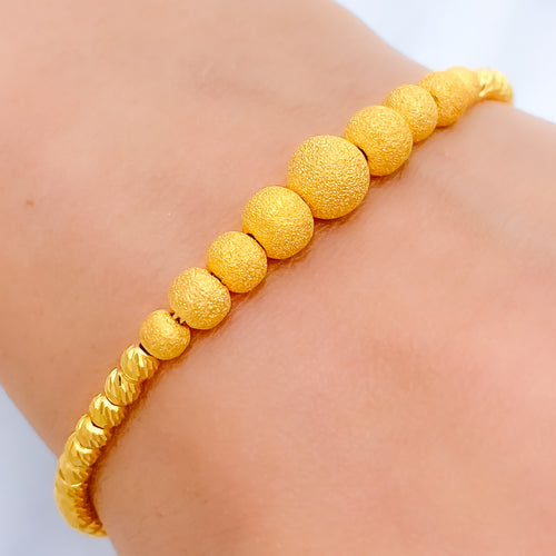 Graduating Sand Finish Orb 22k Gold Bracelet