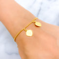 21k-gold-fancy-dangling-heart-charm-bracelet