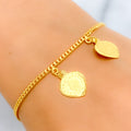 21k-gold-fancy-dangling-heart-charm-bracelet
