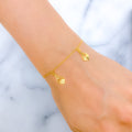 21k-gold-reflective-heart-accented-charm-bracelet